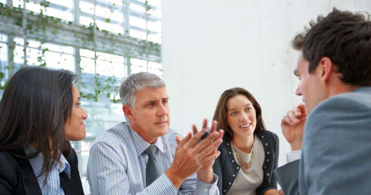 Panel interviewers giving pointers to a male job candidate