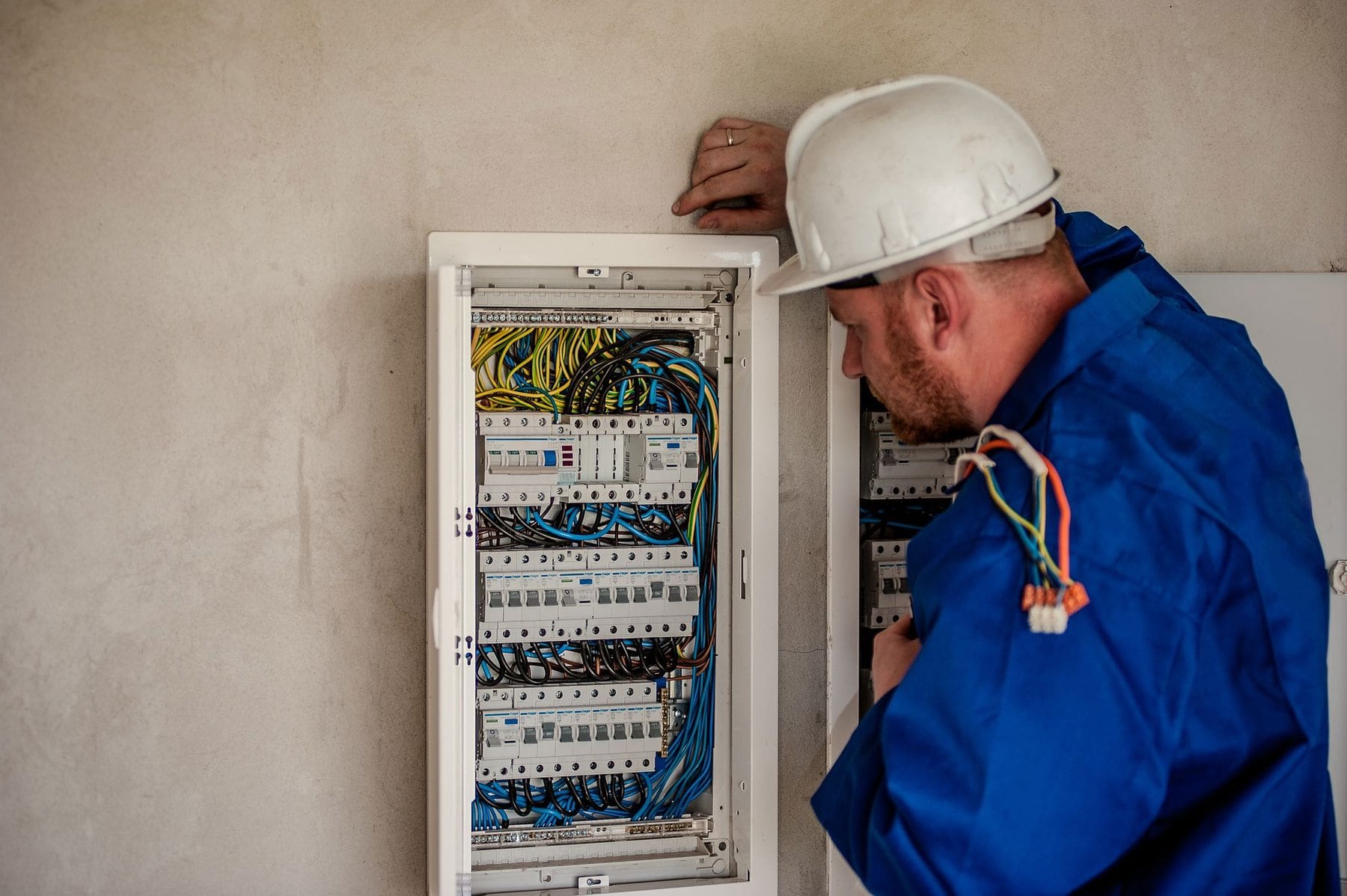 Man looking at the circuit board before fixing