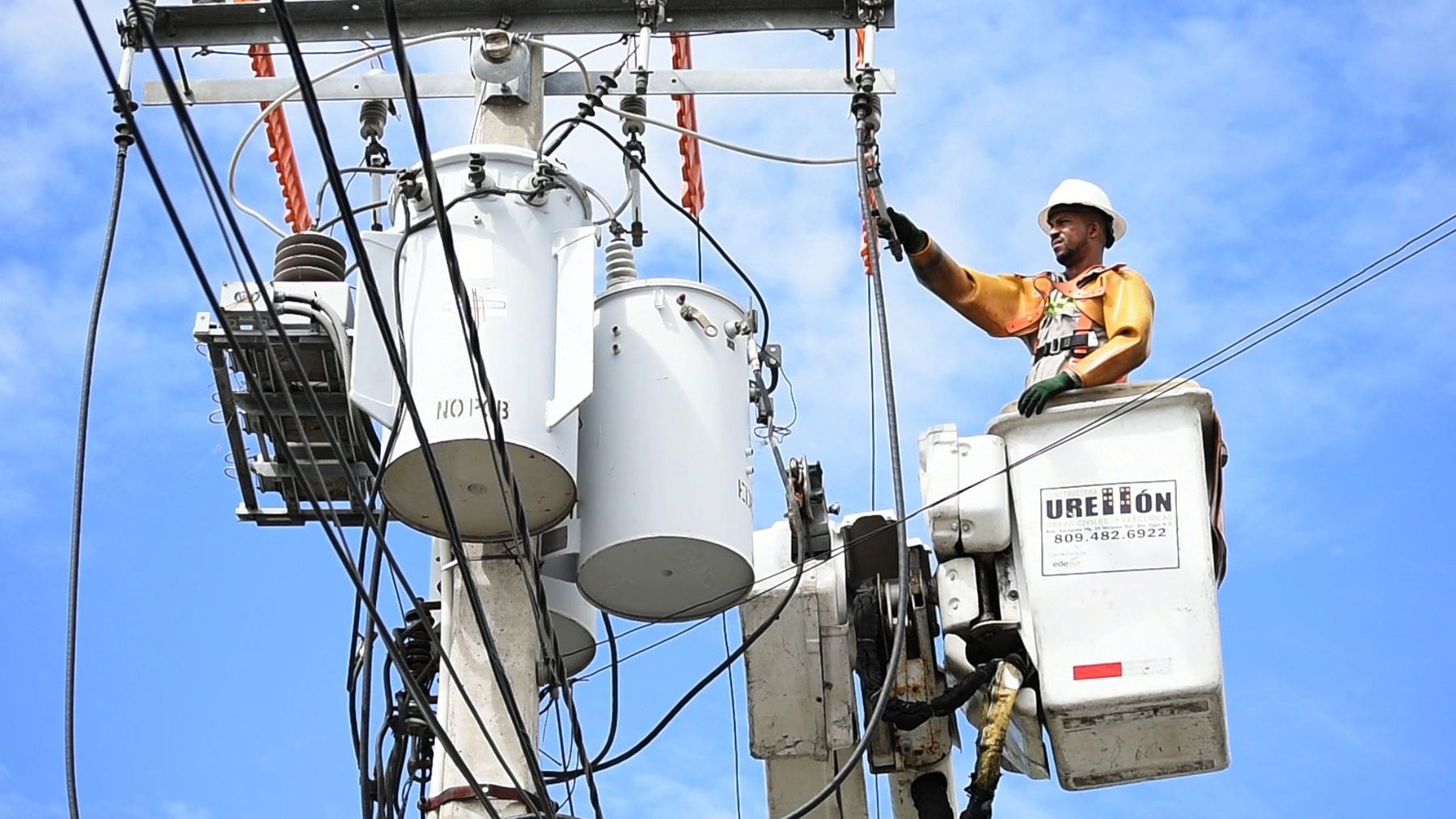 Man fixing an electrical connection outdoors