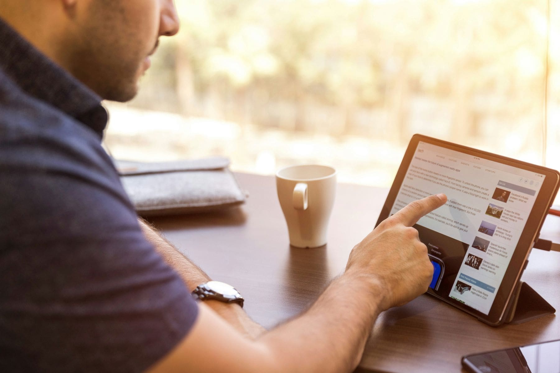 Man swiping through his tablet using his fingers