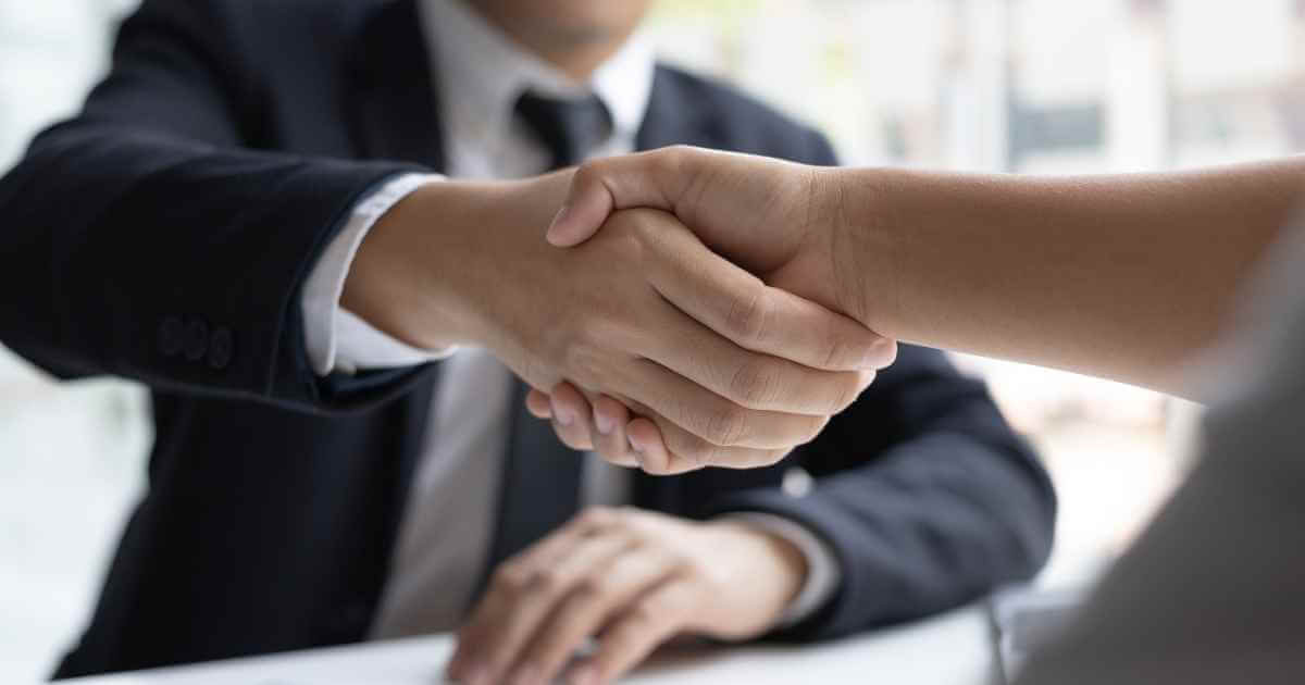 Two people shaking hands in agreement