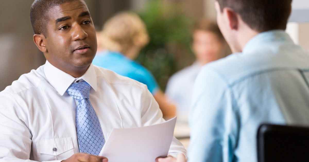 Man holding a piece of paper as he prepares for his interview