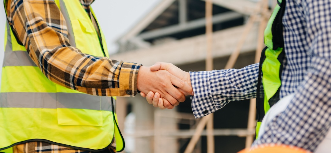 Two workers shaking hands.